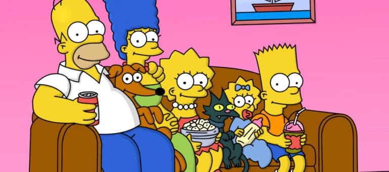 The Simpsons family sits on a couch, enjoying a relaxing evening together.