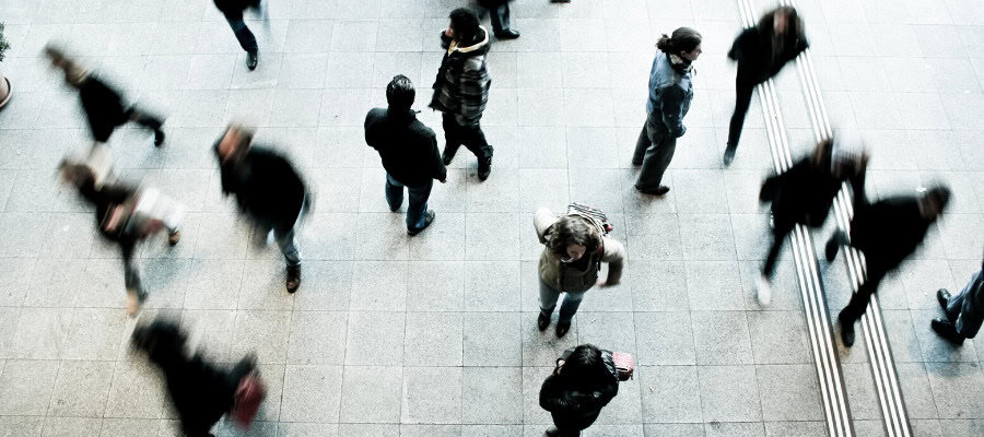 Overhead view of diverse people walking in a busy urban setting, representing the changing workforce and automation's impact on the future of work.