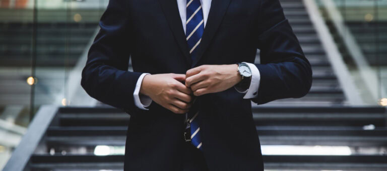 Businessman adjusting his tie, showcasing professional attire relevant to automation and the future of work.