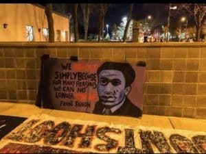 Graffiti portrait of Frantz Fanon with quote: "We simply because for many reasons we can no longer."