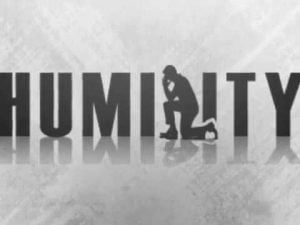 Silhouette of a kneeling man contemplating; the word HUMILITY is overlaid.
