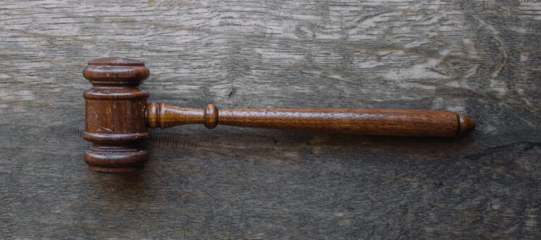 Wooden gavel on rustic wood background