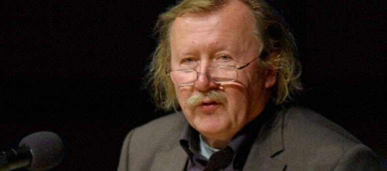 Close-up portrait of author discussing dark knowledge.