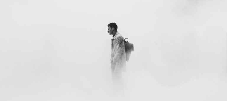 Man with backpack, lost in thought. Philosophical contemplation.