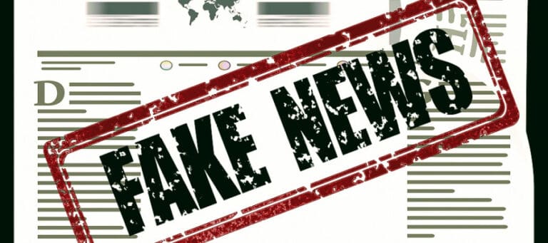 Fake news stamp on a newspaper article. Changing deniers' minds.