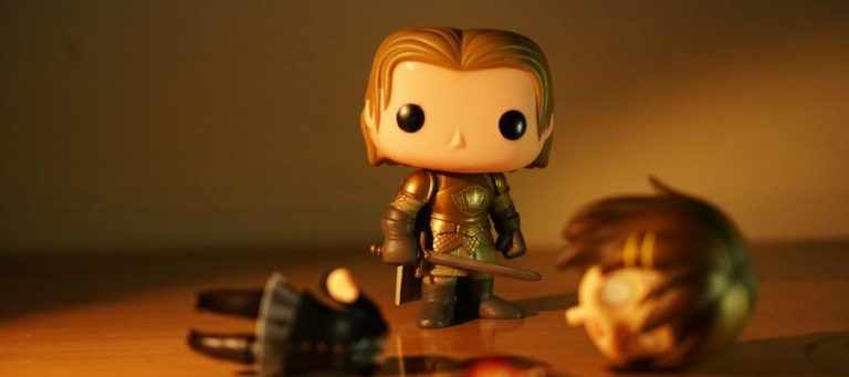 Pop figure of a Game of Thrones character standing over a fallen foe.