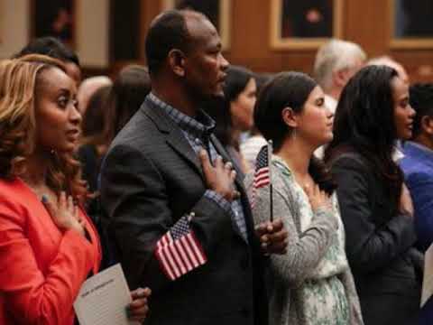 Diverse group of people pledging allegiance to the flag, demonstrating citizenship and justice.