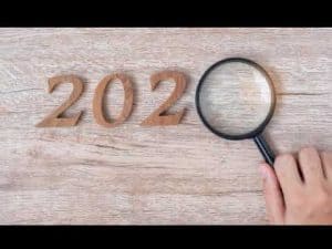Wooden 2020 numerals examined with magnifying glass