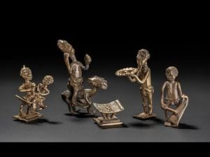 Five bronze Akan figures depicting various activities, illustrating Akan philosophy and personhood.