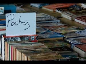 Stack of poetry books with "Poetry" sign. Why poetry matters.