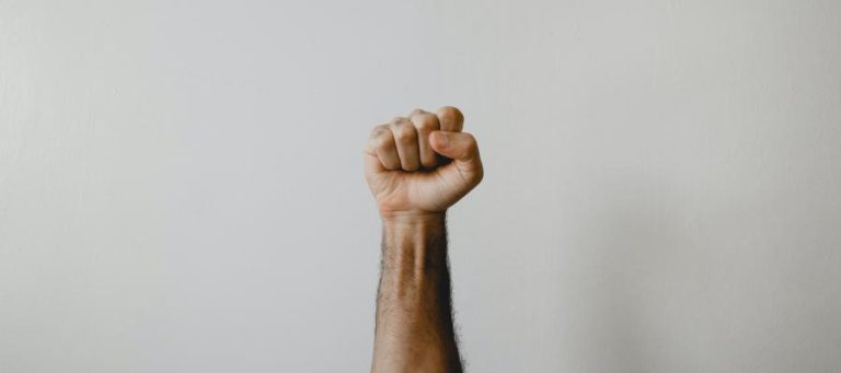 Close-up of a fist raised in the air.