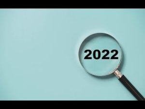 Magnifying glass focusing on the year 2022. Examining 2022.