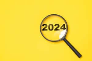 2024-year-inside-magnifier-glass-yellow-background-focus-preparation-new-year-change-start-new-business-target-strategy-concept_50039-4796