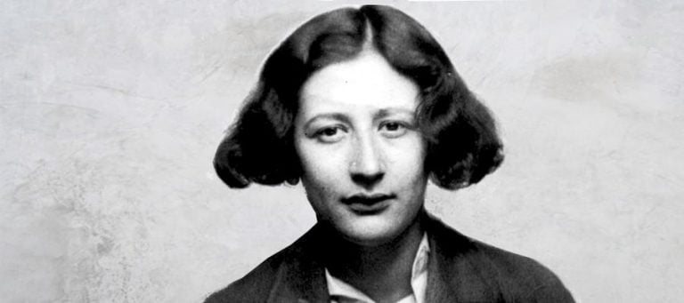 Black and white portrait of young woman with short, wavy hair, looking directly at the camera.
