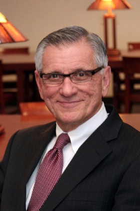 Portrait of a man in a suit, working in an office.