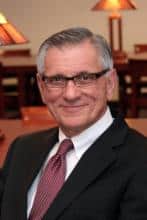 Headshot of a man in a suit and tie