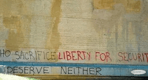 Those who sacrifice liberty for security deserve neither" graffiti on a wall