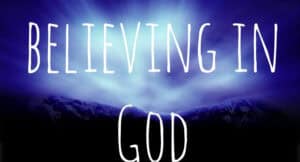 Mountains at sunset with text overlay: Believing in God