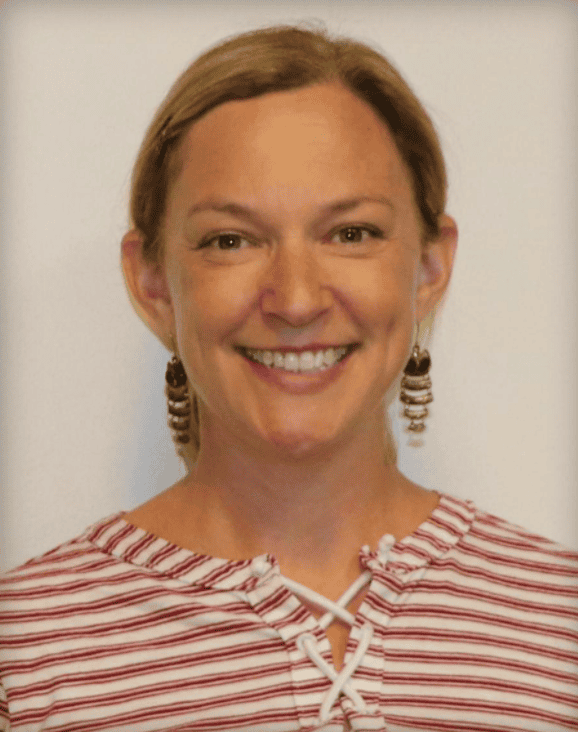 Headshot of a woman with blonde hair wearing a red and white striped shirt.