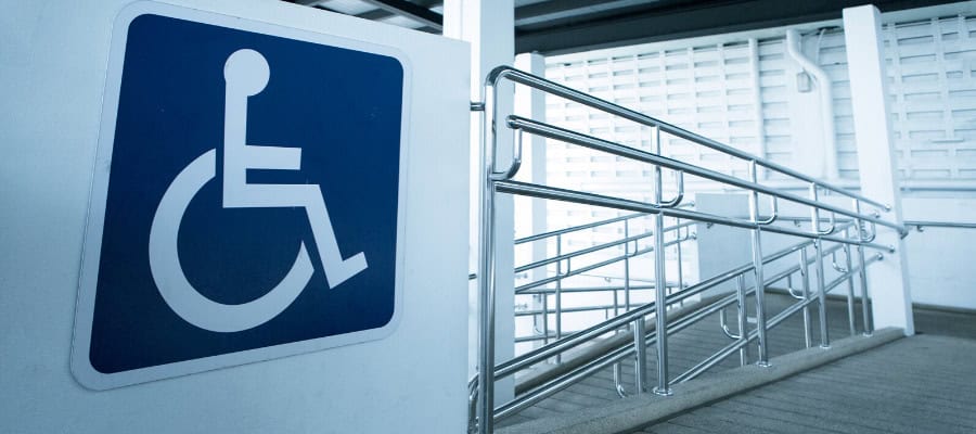 Accessible ramp with handrails and disability symbol