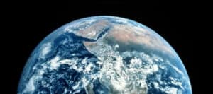 Earth from space, showing Africa and surrounding oceans. International aid efforts address global poverty on this scale.