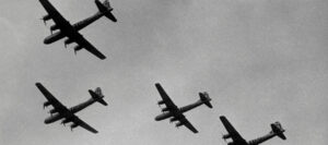 Four B-17 Flying Fortresses in formation, illustrating the ethical complexities of aerial warfare.