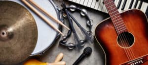 Acoustic guitar, drums, keyboard, and percussion instruments arranged together. The philosophy of music.
