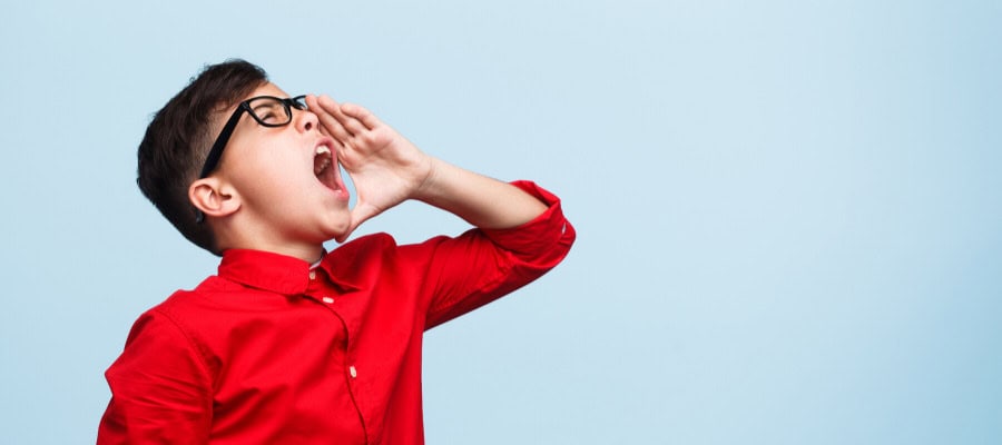 Boy in red shirt shouting, philosophical expression