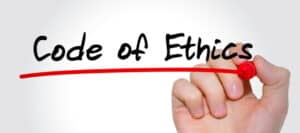 Hand writing 'Code of Ethics' with red marker; emphasizing journalistic integrity.
