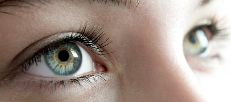 Close-up of a woman's eye, showcasing its intricate details and natural beauty.