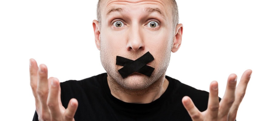 Man with mouth taped shut, hands outstretched, illustrating censorship.