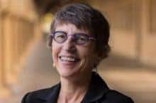 Headshot of smiling woman wearing glasses