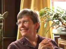 Smiling woman with short hair wearing glasses