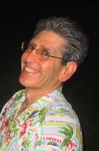 Happy man wearing a Hawaiian shirt at night.