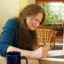 Woman writing in notebook, poetry inspiration