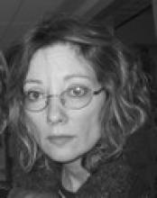 Close-up portrait of a woman wearing glasses.