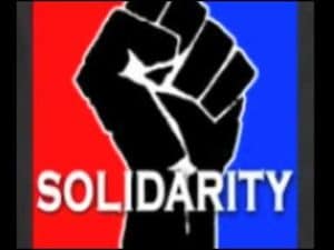 Black fist raised high, "Solidarity" text. Symbol of Black unity and power.