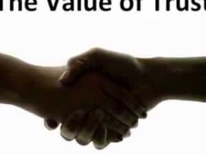 Two hands clasped together in a handshake, symbolizing trust.