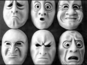 Six masks showing various human emotions, including sadness, surprise, anger, and fear. Illustrates concepts of freedom, blame, and resentment.
