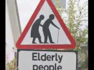 Warning sign: Elderly people crossing. Challenges of an aging population.
