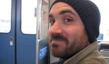 Man with mustache and knit cap on public transportation