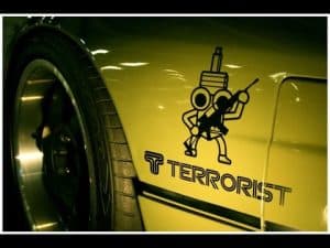 Close-up of a yellow car with a graphic of a robot terrorist and the word "Terrorist".