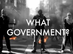 Protesters in an urban setting during a demonstration, with the words "What Government?" superimposed. Anarchy?