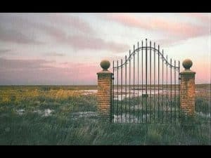 Ornate iron gate at sunset, symbolizing justice across boundaries.