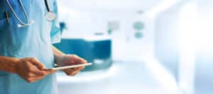 Doctor using tablet computer in hospital. Paternalism in healthcare.