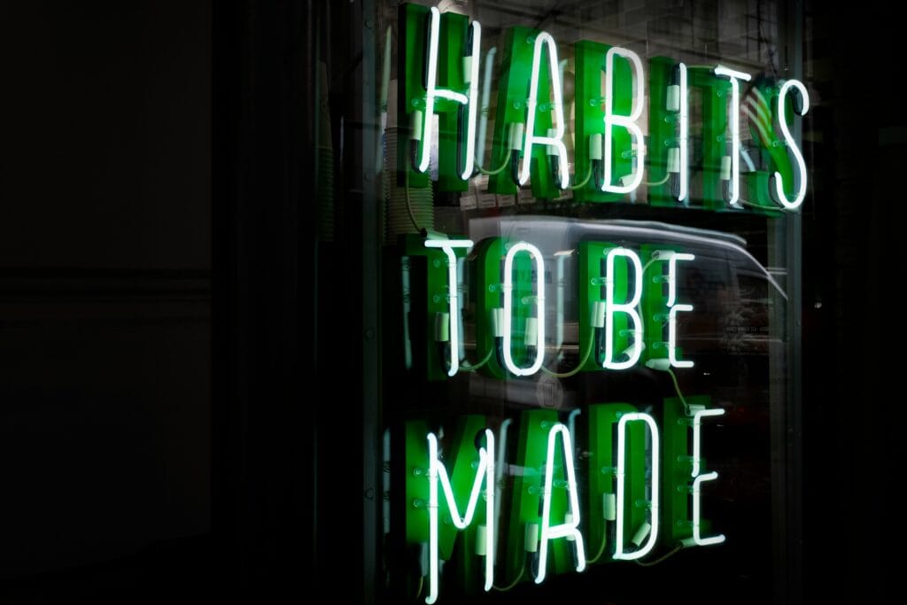 Neon sign: "Habits To Be Made